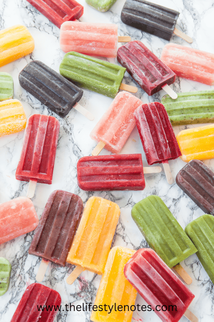 Easy and Healthy Homemade Popsicles. Variety of different color popsicles.