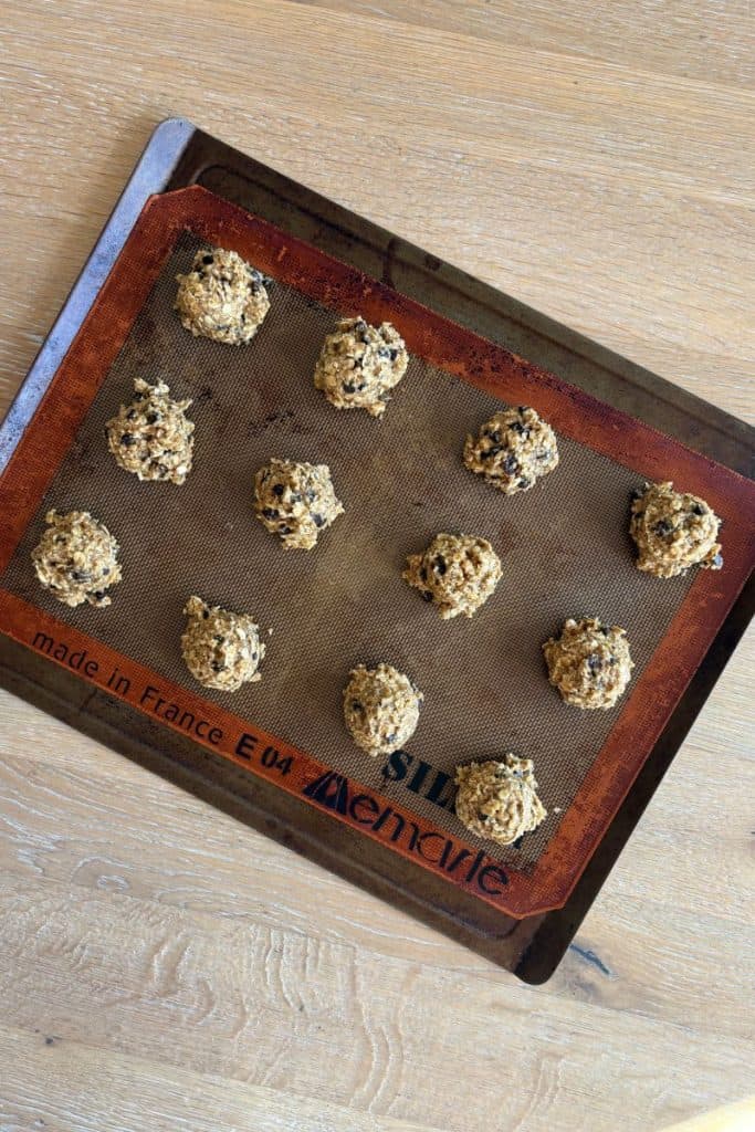 Baking tray with scoopfuls of cookie dough ready to go into the oven.