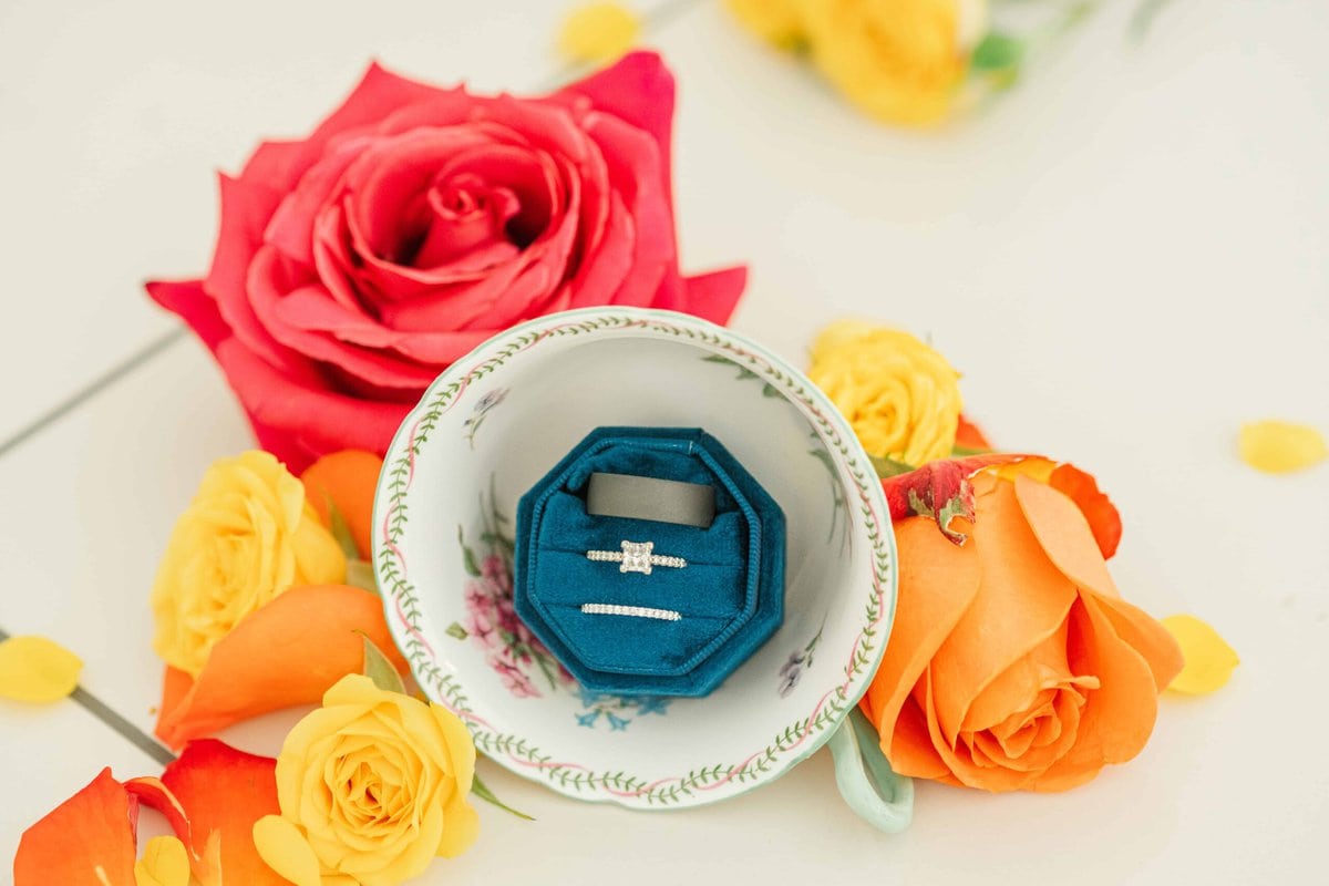 Detail photo of wedding rings on elegant white tiles inside The Grande Victorian