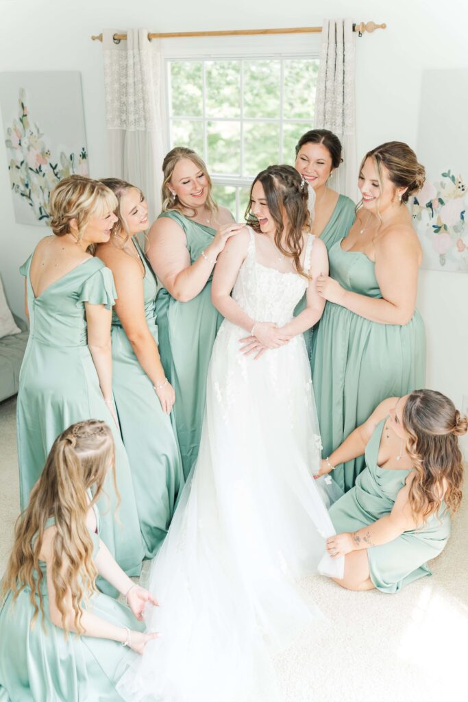 Bride and bridesmaids laughing together at Heron Hill Venue