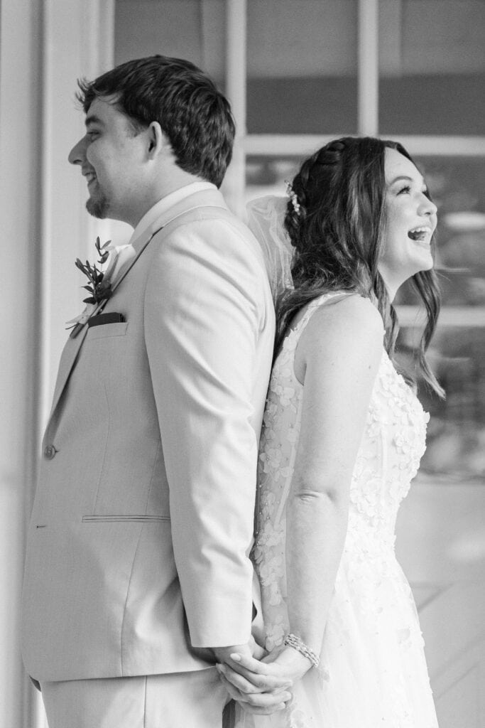 Bride laughing as she exchanges vows during first touch at Heron Hill Venue