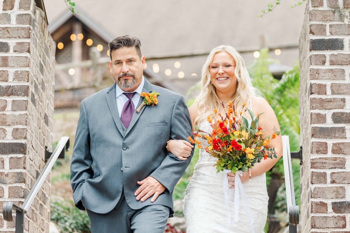 Bride walking up the aisle during outdoor wedding ceremony facing the river