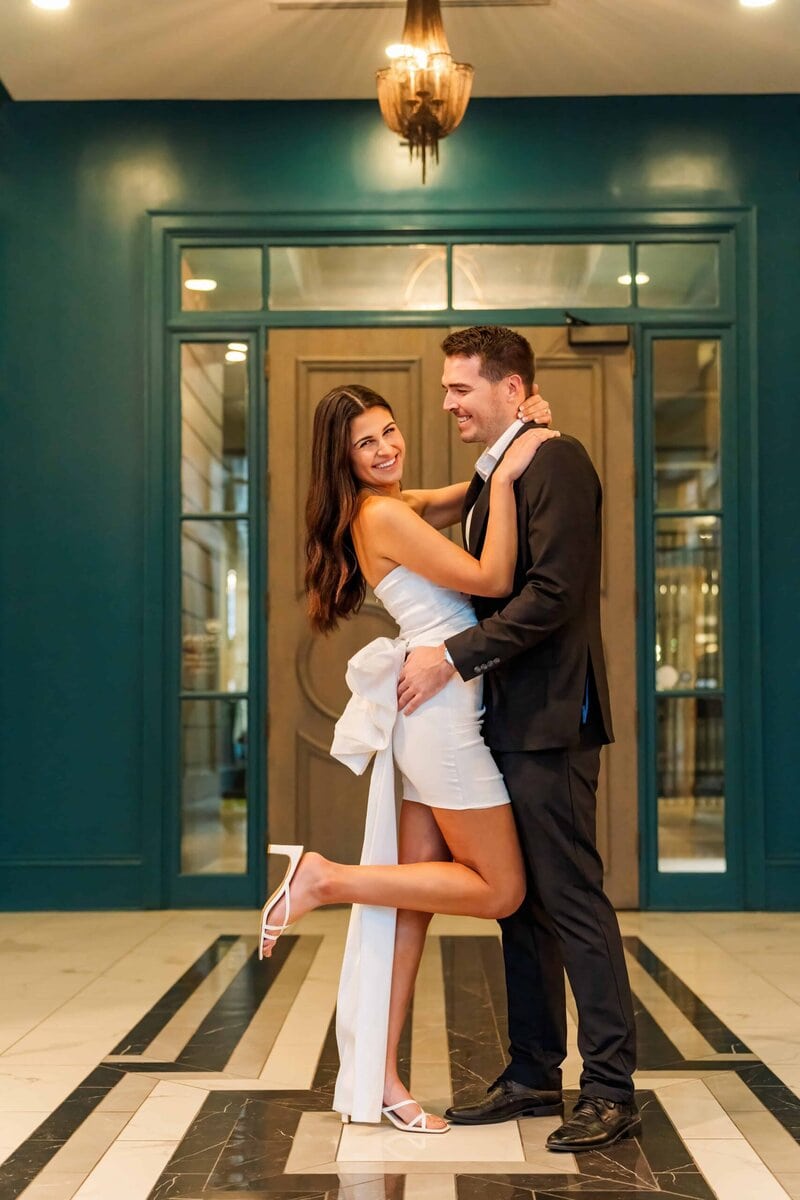 Laughter filled moment during Uptown Charlotte engagement session indoors