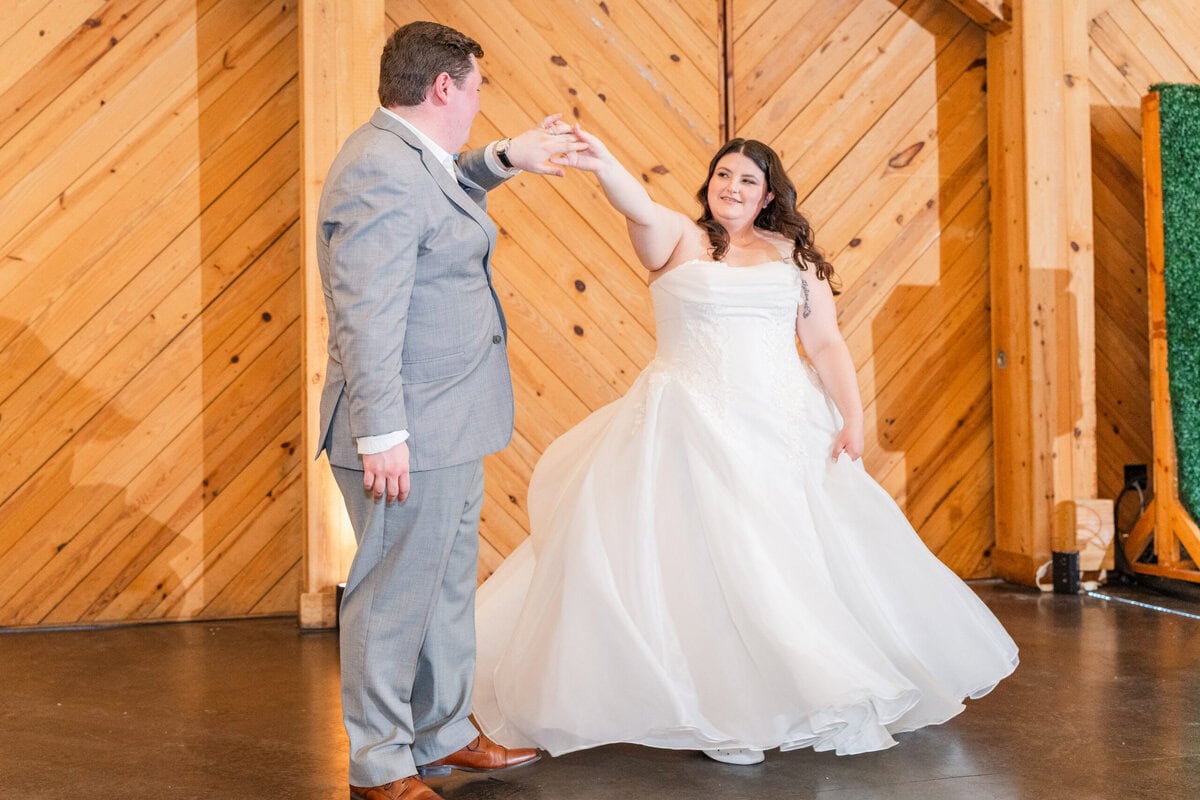 Ball gown bride twirling in Alexander Homestead gardens during golden hour
