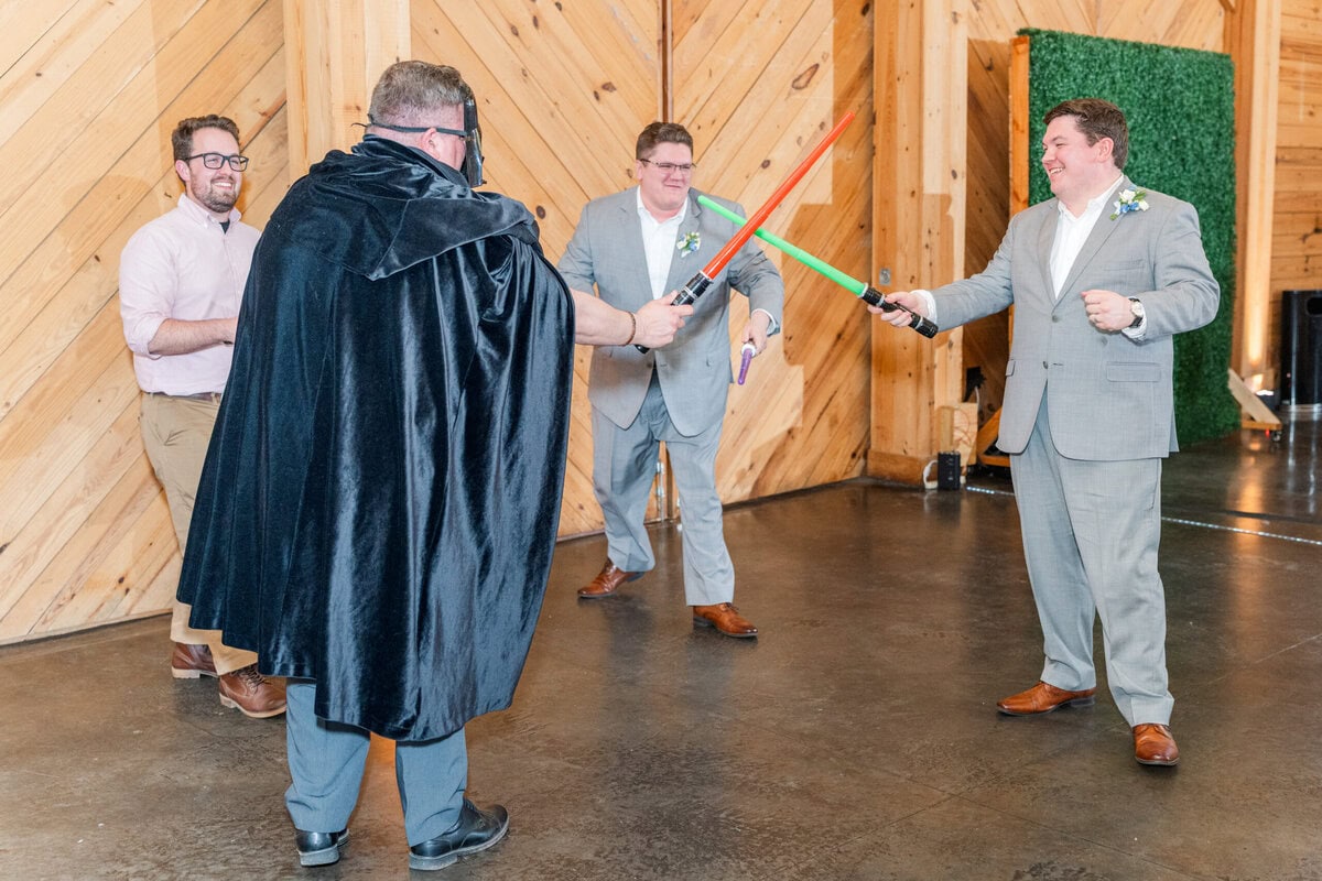 Groom's family Star Wars lightsaber battle on dance floor at Alexander Homestead reception