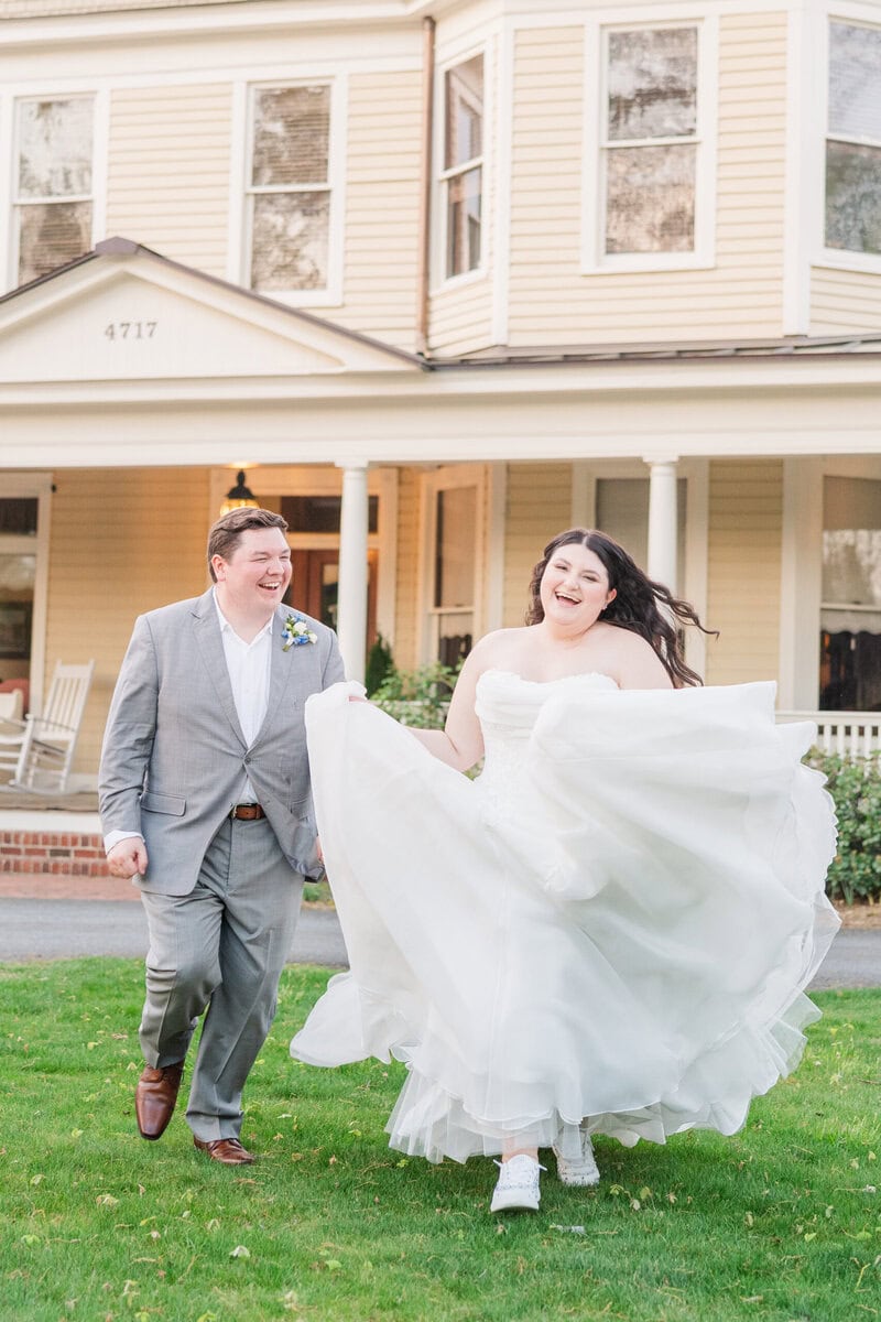 Bride in full skirt ball gown running through Alexander Homestead gardens
