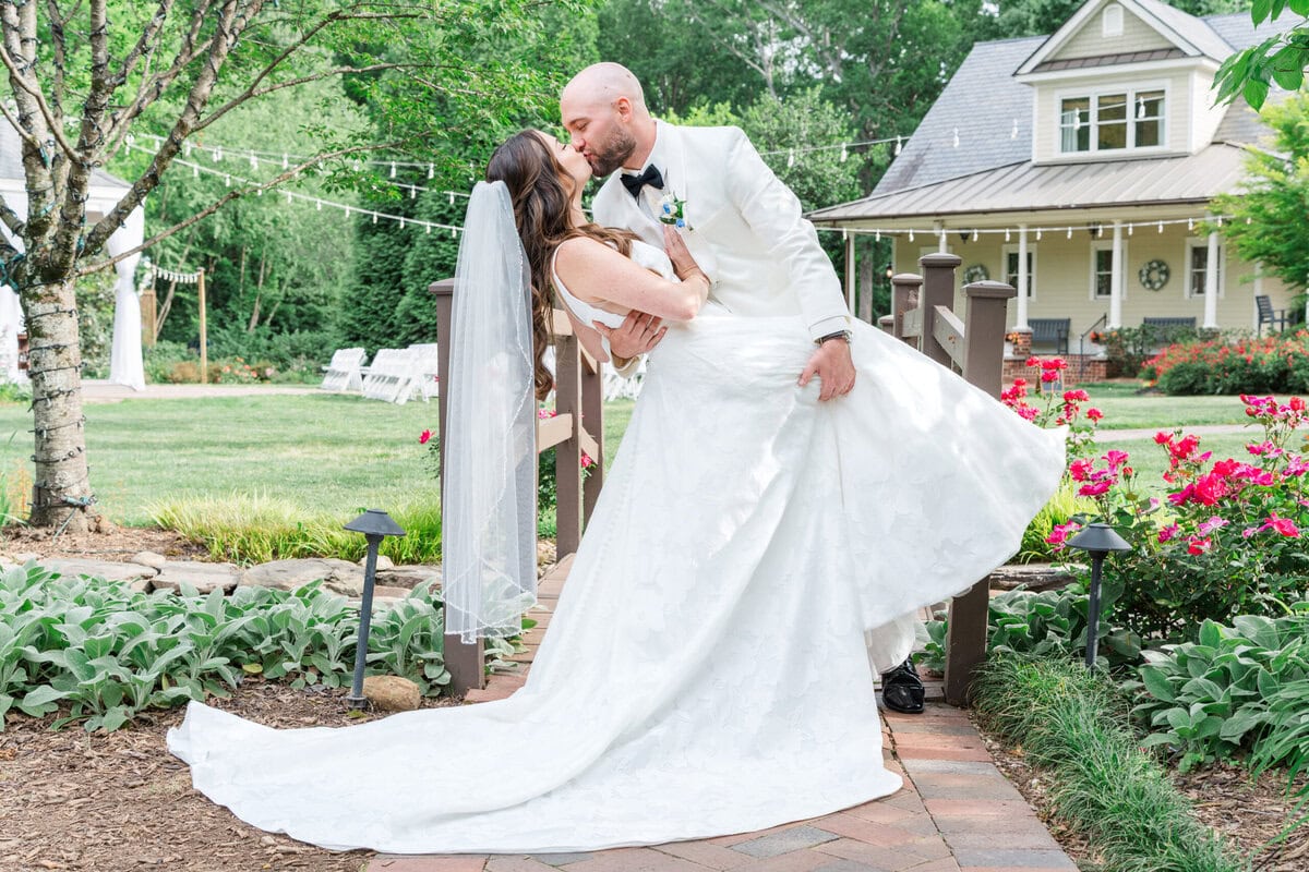 Alexander Homestead white wedding suit moment where Michael dips Liz on the famous garden bridge
