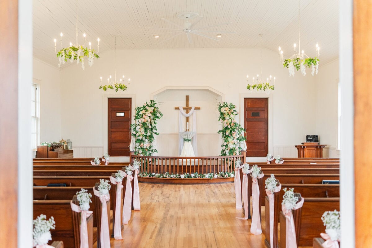 white chapel interior charming pews wooden floors Mariposa Chapel Iron Station NC