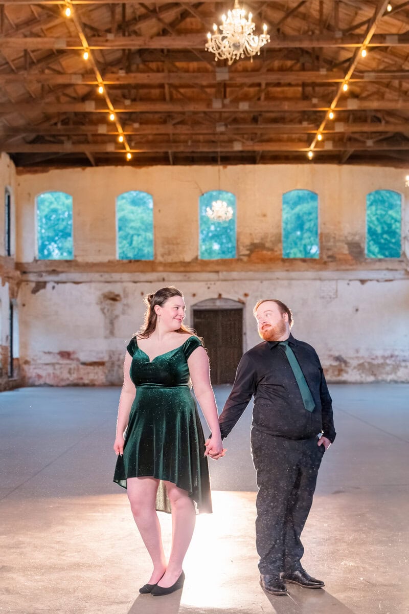 Charlotte NC engagement photographer using off-camera flash for dramatic rain portraits at Providence Cotton Mill