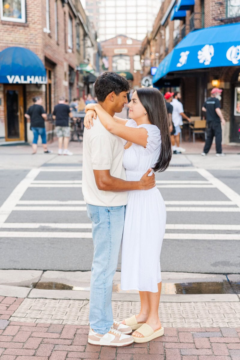 Casual engagement photos Charlotte NC couple embracing on 7th Street brick crosswalk