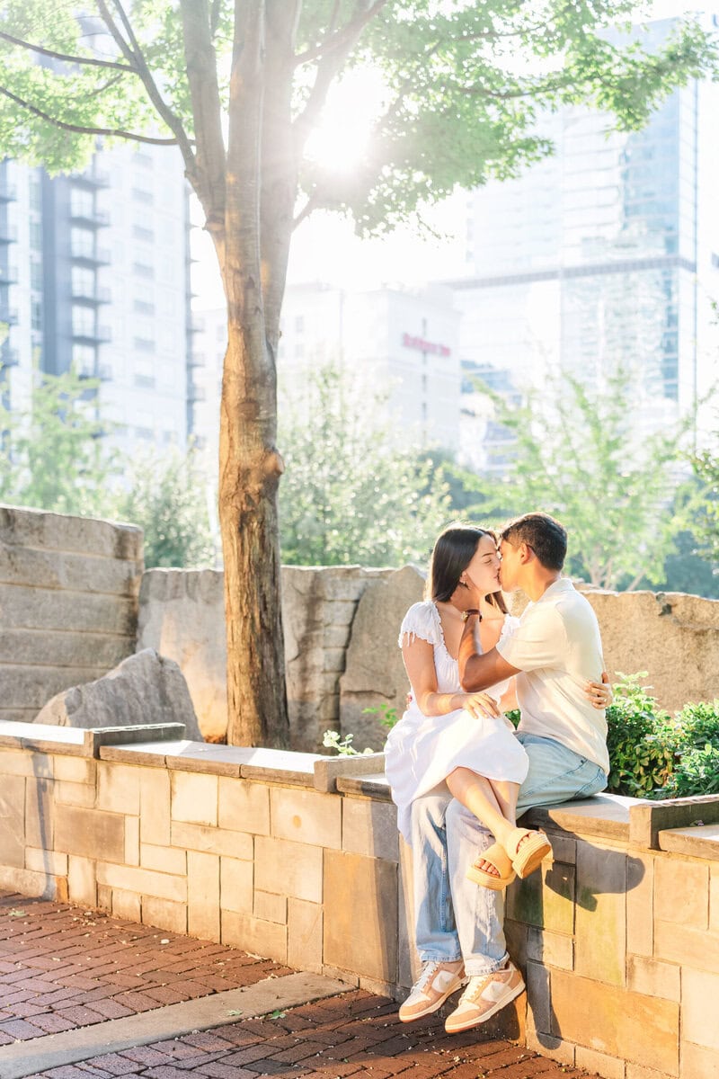 Couple sitting on stone ledge near 7th Street Public Market Charlotte