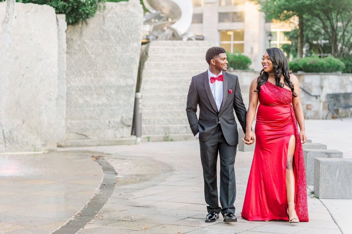 Couple walking hand in hand near French Quarter fountain at Romare Bearden Park