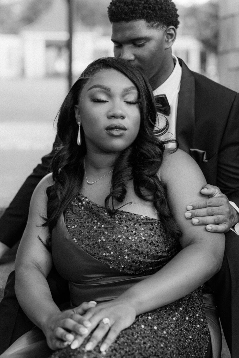 Black and white portrait of engaged couple embracing in Uptown Charlotte