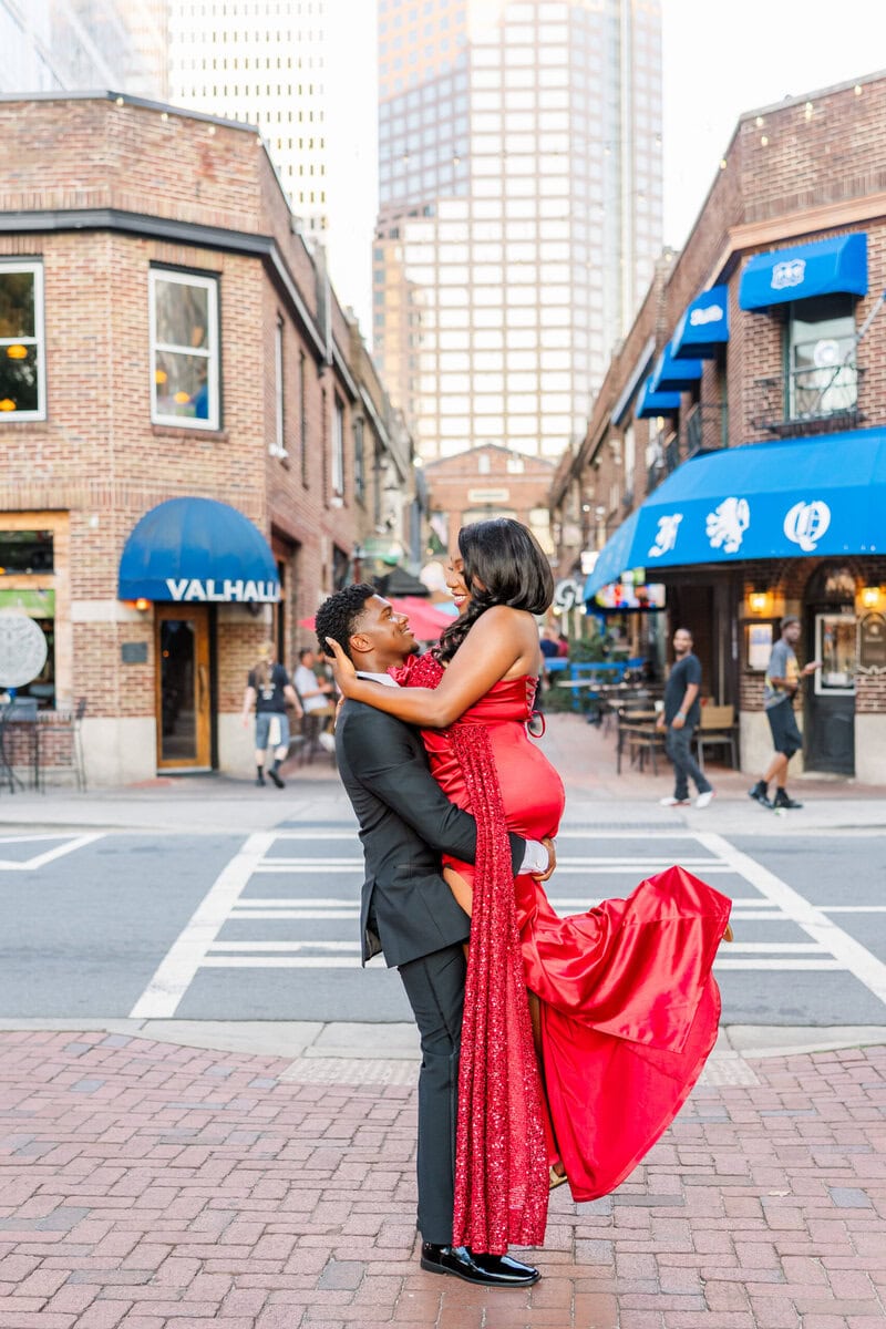 Couple dancing in the street near Romare Bearden Park during golden hour engagement session