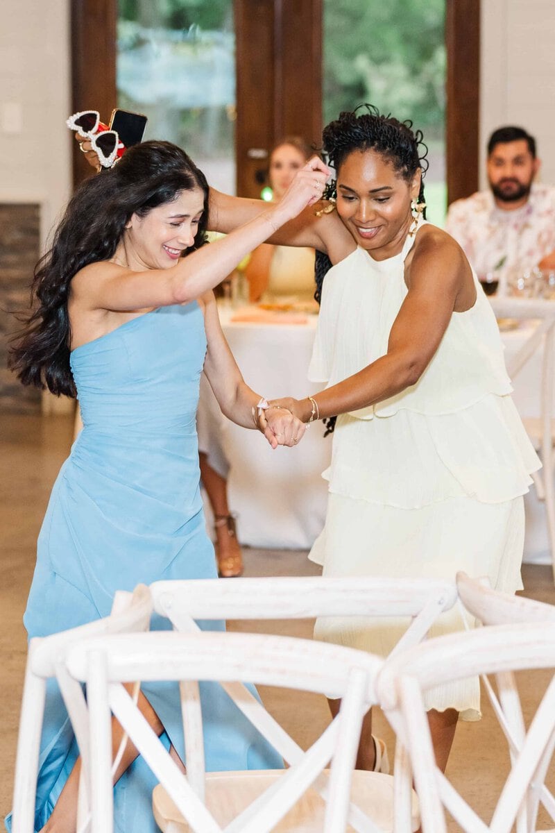 Guests running during a musical chairs scavenger hunt at a Monroe NC wedding reception