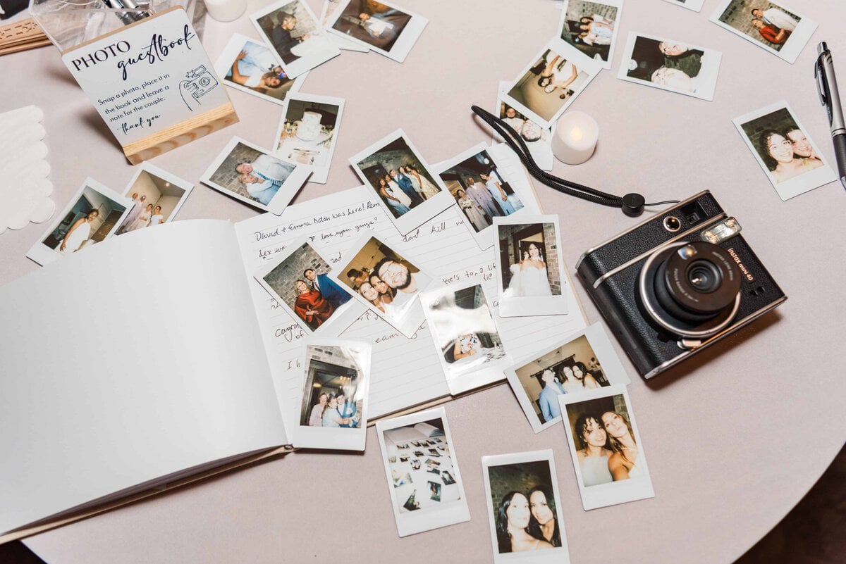 Polaroid guest book on a table at a Rolling Hill Venue wedding reception