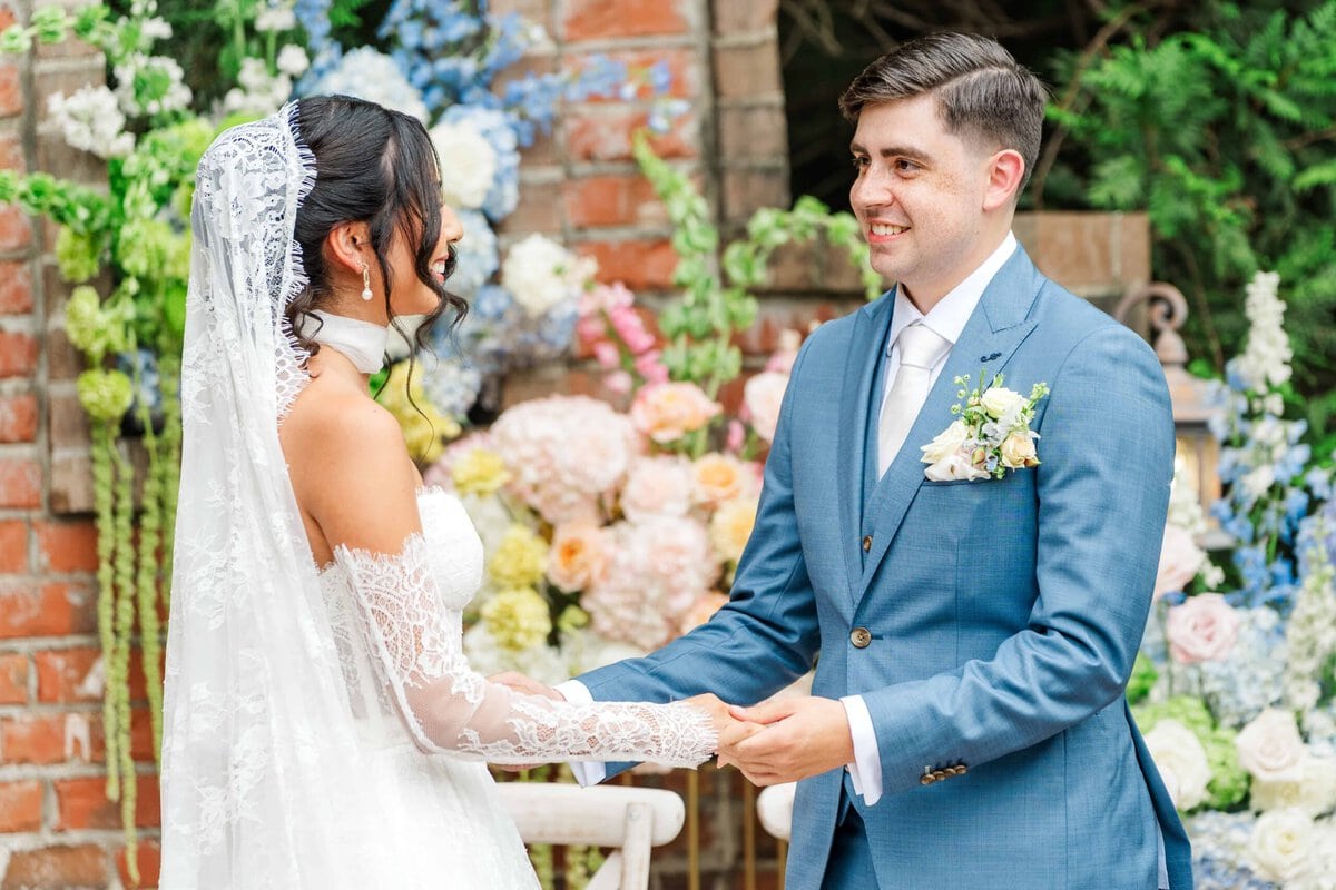 Bride and groom holding hands during their Spanish ceremony at Rolling Hill Venue