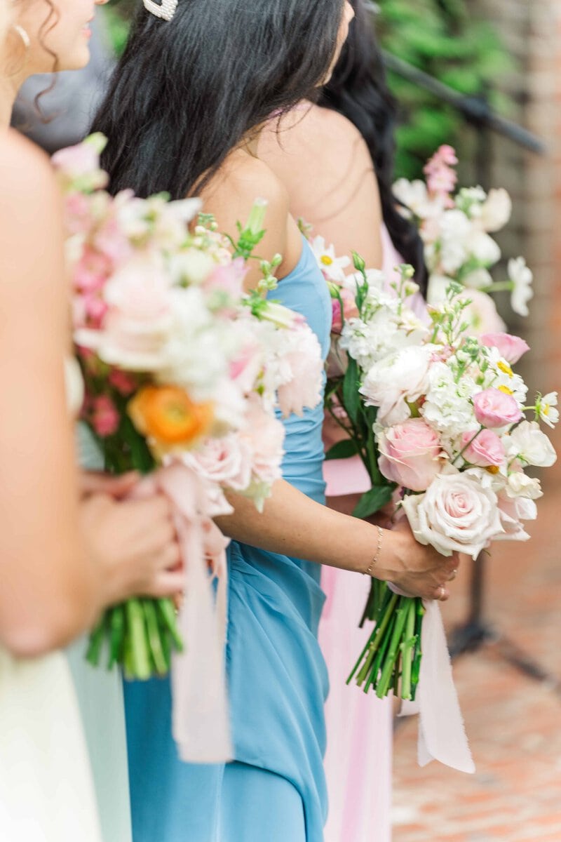 Pastel bridal bouquet with roses, ranunculus, and daisies photographed by a Rolling Hill Venue wedding photographer