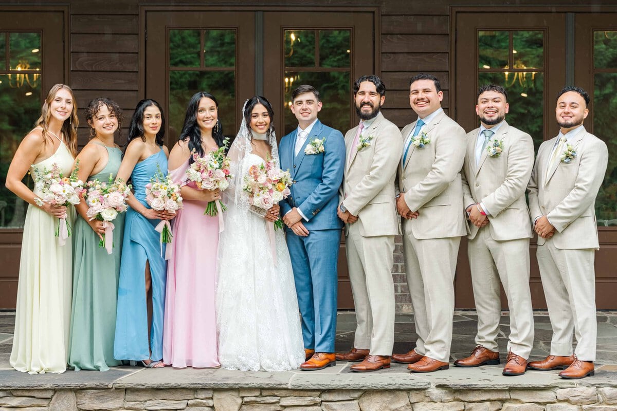 Bride and groom with their wedding party under the covered area at Rolling Hill Venue