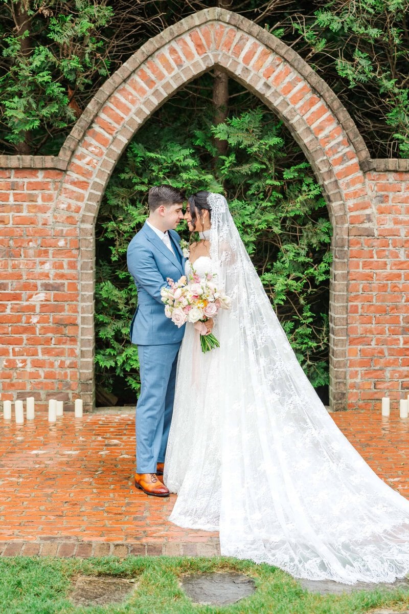 Rainy day wedding portrait at the brick arches captured by a Rolling Hill Venue wedding photographer