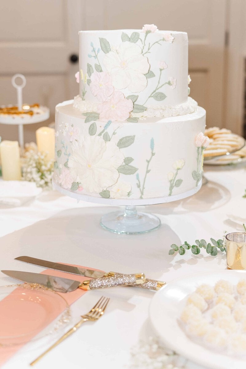 Wildflower painted wedding cake at a Rolling Hill Venue reception in Monroe NC