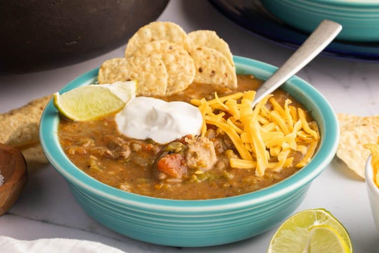 Colorado pork green chili served with sour cream, cheese, chips and lime