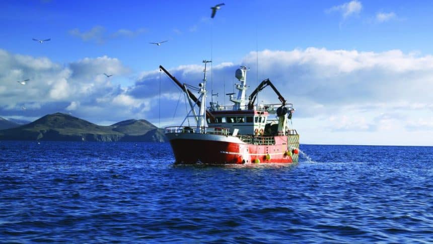 Fishing vessel at sea in a commercial fishing industry publication, with gear and industry equipment.