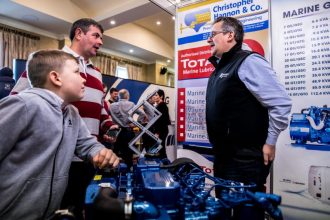 Fishing industry exhibition with fishermen discussing gear and equipment at Irish Skipper Expo 2020.