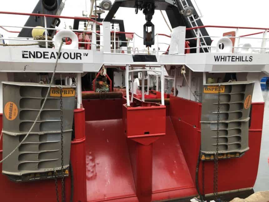 Commercial fishing vessel Endeavour IV with Osprey trawl doors at port, industry equipment, and gear.