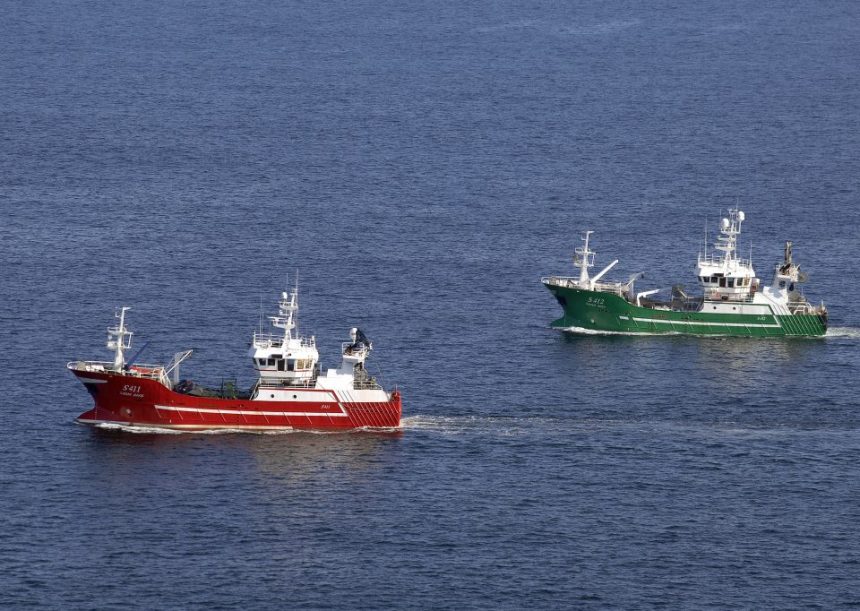 Two fishing vessels navigating open waters in a commercial fishing industry setting.