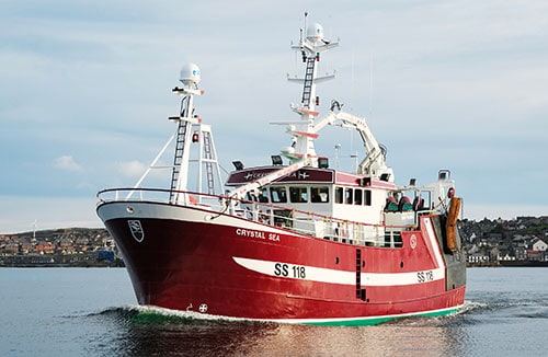 Commercial fishing vessel Crystal Sea with gear and industry equipment in port.
