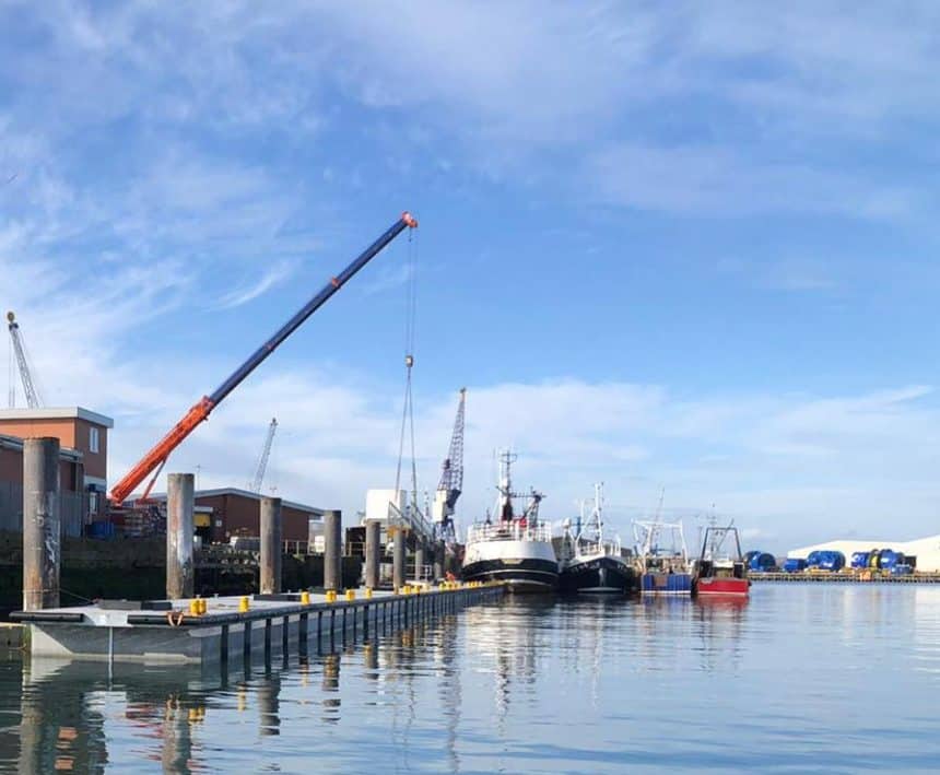 Fishing vessels docked at Hartlepool Harbour with industry equipment and gear visible in a port for.
