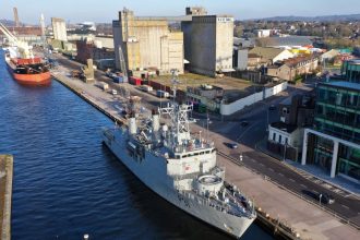 Commercial fishing vessel docked at port in Cork, Ireland, industry equipment visible.