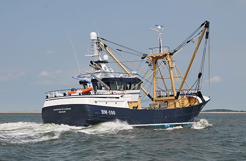 Fishing vessel with gear and equipment in a commercial fishing port, industry focus.