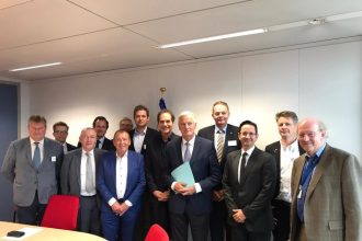 Group of fishermen and industry officials at a commercial fishing industry event in a conferenceroom.