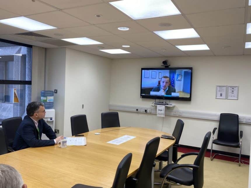 Fishermen and industry officials discuss fishing industry updates via video conference in a meeting.