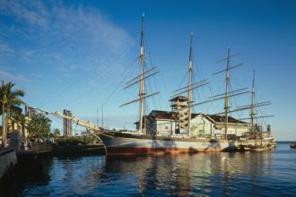 Historic fishing vessel docked at port, commercial fishing industry scene, industry equipment, port,.