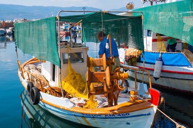 Fishing boat with gear and crew in port, commercial fishing industry publication, fishing vessels, C.