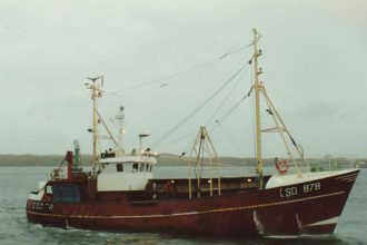 Fishing vessel with gear and industry equipment in a commercial fishing port, 25 Years Since Carrick.