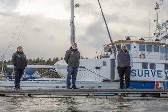 Fishing vessels docked at port with crew members, industry gear, and equipment visible, commercial f.