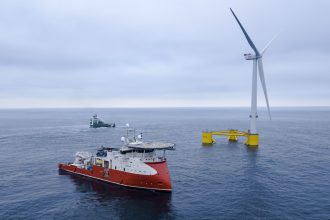 Fishing vessels near floating offshore wind turbine in commercial fishing industry context.