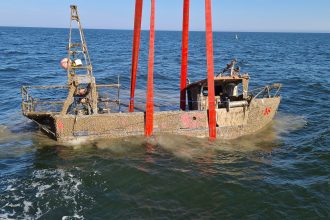 Fishing vessel in open sea with gear and industry equipment, commercial fishing industry publication.