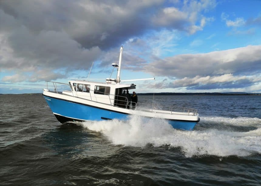 Fishing vessel cruising through open water in a commercial fishing industry setting with industry-fo.
