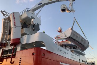 Fishing vessel with trawldoors and industry equipment in port, commercial fishing industry context,.