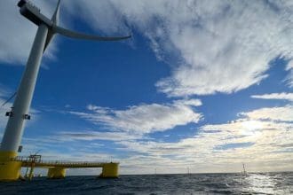 Offshore wind turbines near fishing vessels in a commercial fishing industry setting.
