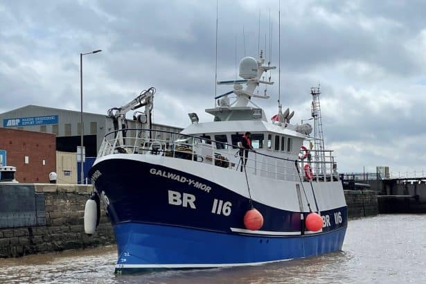 Fishing vessel Galwad-Mor docked at port, commercial fishing industry scene, industry equipment, and.
