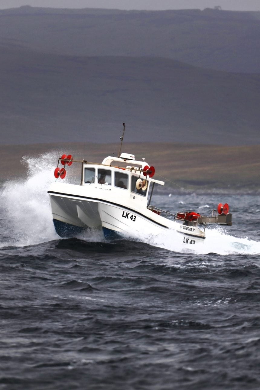 Fishing vessel LK 43 navigating rough seas in a commercial fishing industry setting.