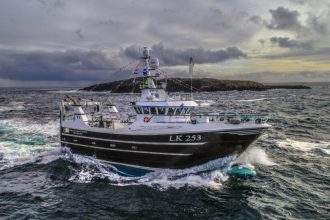 Fishing vessel LK 253 navigating rough seas in a commercial fishing industry setting.