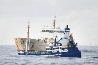 Commercial fishing vessel in Irish EEZ with gear and industry equipment, port scene, industry focus.