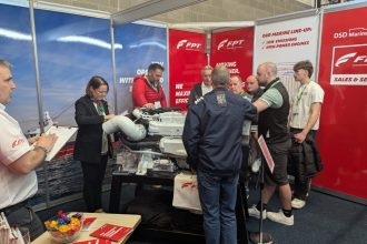 Fishermen and industry professionals examine fishing vessel equipment at Irish Skipper Expo, Ireland.